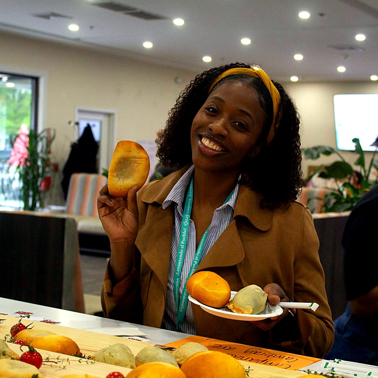 Guest holding an arepa, smiling